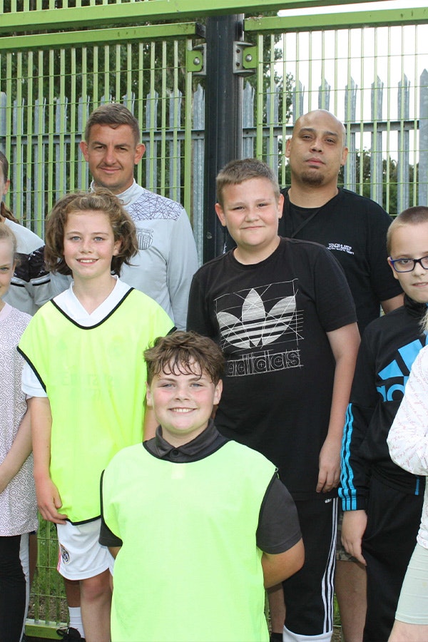 Parent, support workers and children after a football match