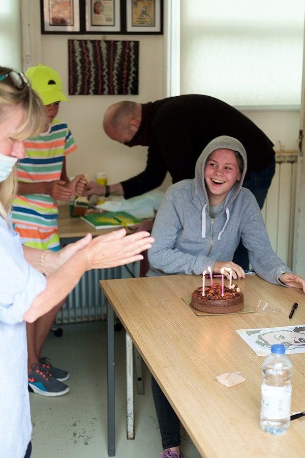 Carers with child with a birthday cake